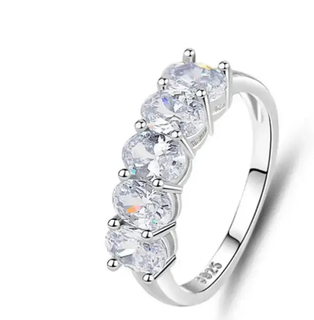 Stylish silver ring with five sparkling moissanite stones, perfect for stacking and everyday wear.